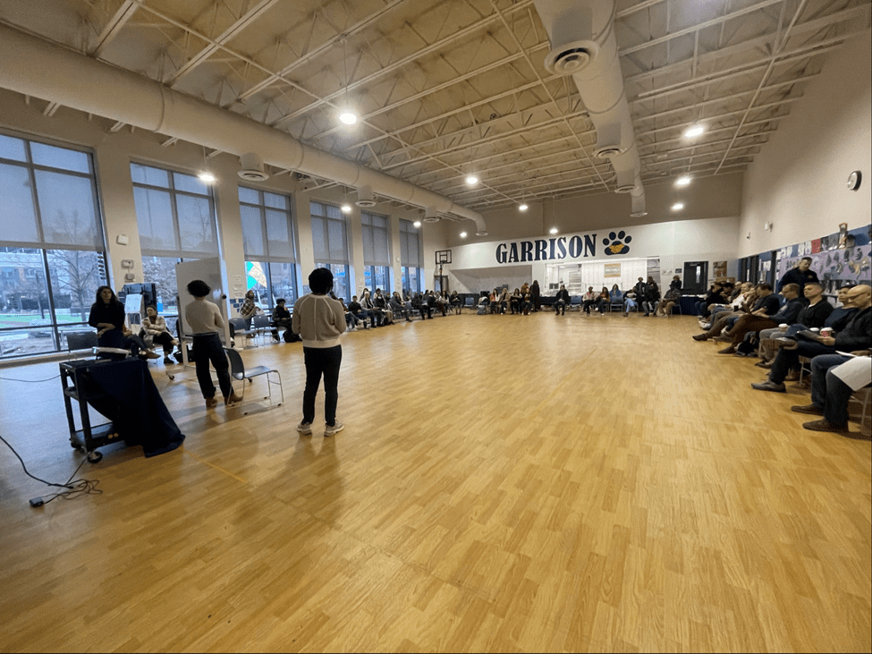 Garrison Elementary School parents gather in a gymnasium to review designs.